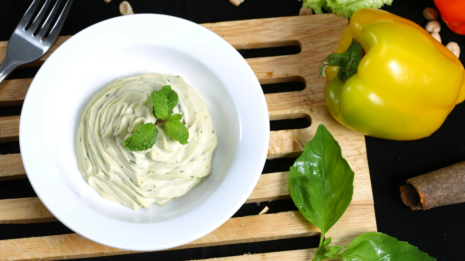 bowl full of cucumber dill sauce and a yellow bell pepper