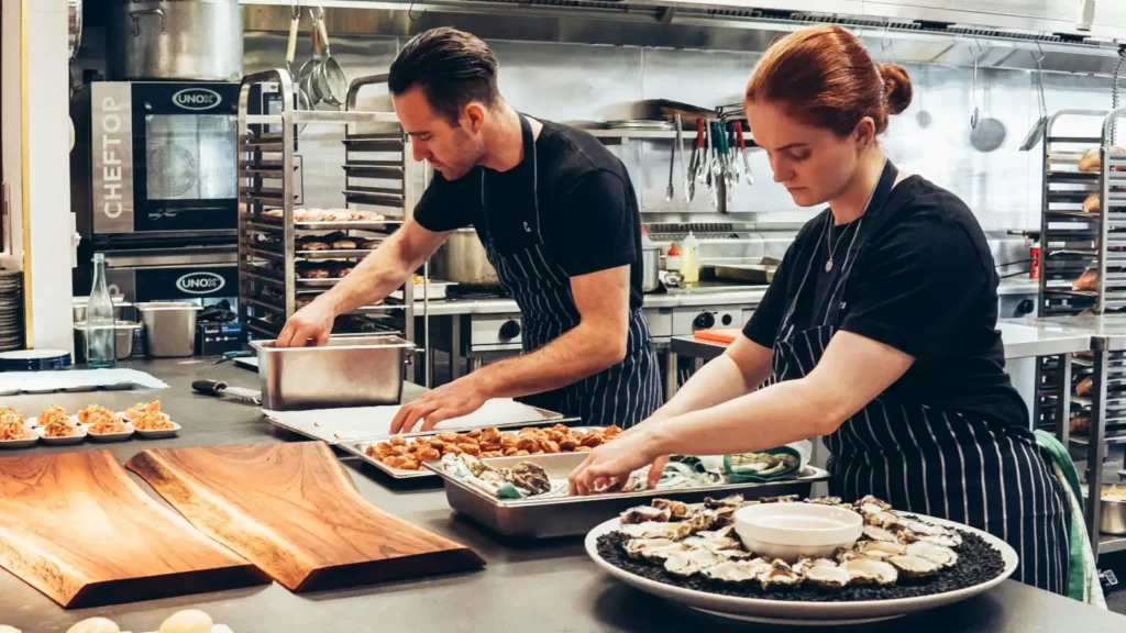 photo of two people cooking a meal