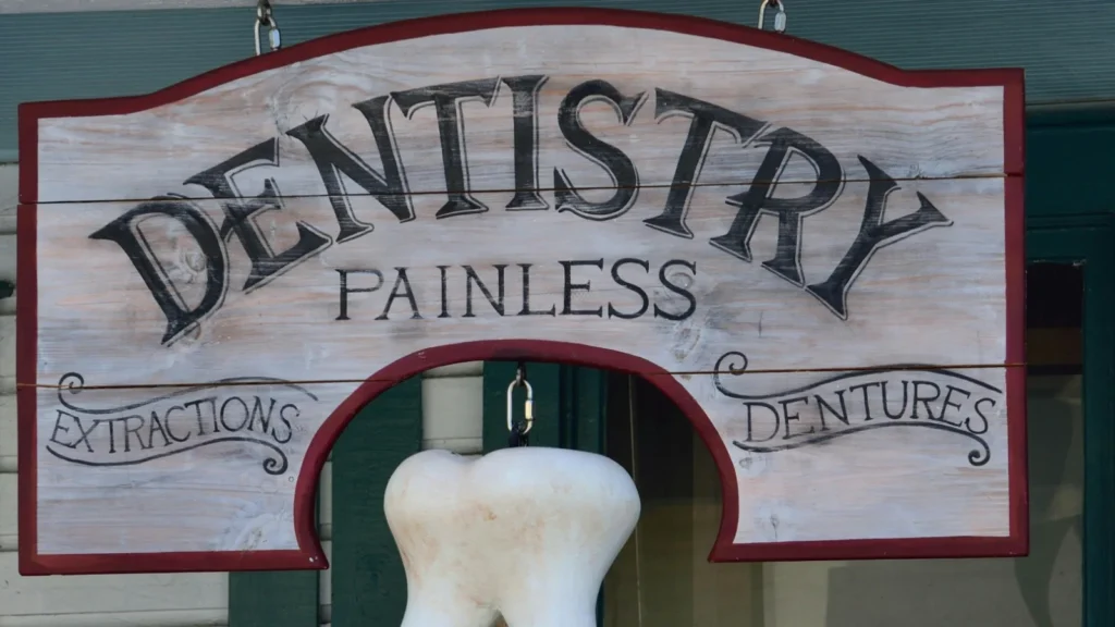 photo of a dentist office sign that reads "painless extractions, dentures"